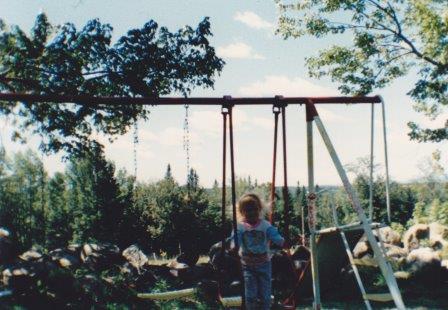 Child on Farm Swing Set